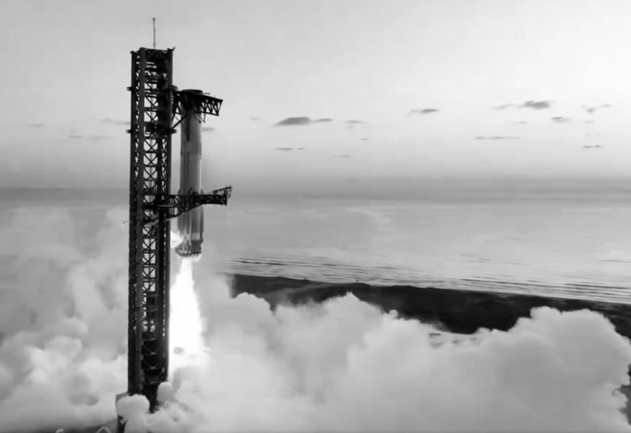 Starship lifting off from the launch tower at Starbase, Texas, in a cloud of steam