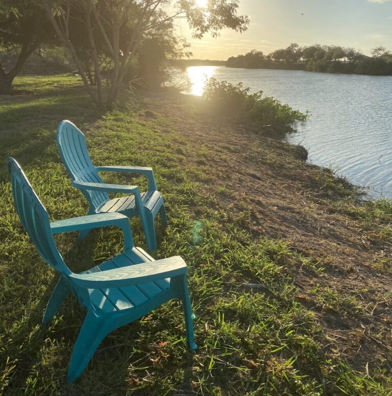 Adirondack chairs on the Rio Grande riverbank at the Rocket Ranch campground
