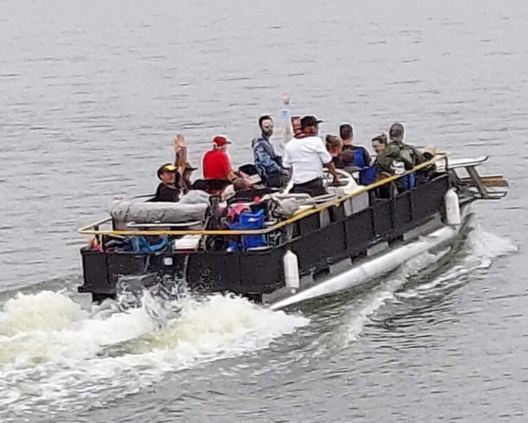 Guests on a Rocket Ranch pontoon boat ride on the Rio Grande