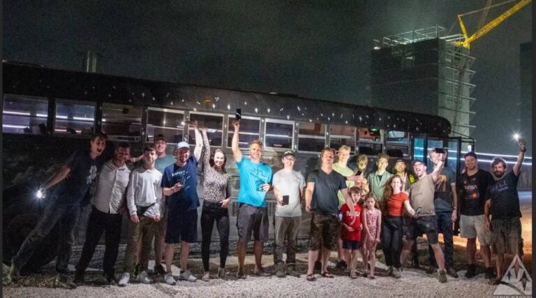 Rocket Ranch guests with the shuttle bus at night near Starbase